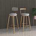 Modern Luxury Bar Stools with Golden Metal Legs and Gray Padded Seats in Contemporary Interior