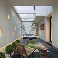 Courtyard Garden Interior Design With White Walls Circular Cutouts Skylight Sofa And Green Plants