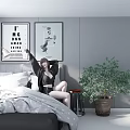 A Woman Sitting On Bed With Framed Posters Gray Wall Floor Lamp And Potted Plant