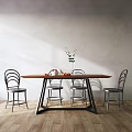 Modern wooden dining table set with metal frame chairs and green plant vase fruits