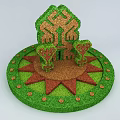 Garden Ornament With Circular Green Base Red Patterns House Shaped Topiary And Small Trees