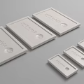 White Rectangular Product Tags with Circular Logo and Text in Multiple Sizes