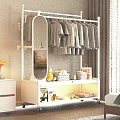 White Clothes Rack With Hanging Clothes Folded Towels Fruits And Mirror On Wheels
