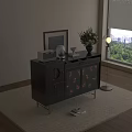 Black Dresser with Gold Legs and Pink Feather Patterned Doors and Decorative Items Near Window