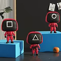 Toy Figures in Red Outfits With Square Circle Triangle Heads Standing on Blue Blocks