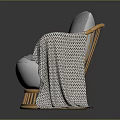 Cozy Rattan Chair with White Cushion Gray Geometric Pillow and Patterned Blanket