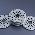 Multiple Perforated Circular Washers Stacked With Central Holes And Textured Surface