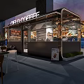 CELO COFFEE Cafe Exterior With Outdoor Seating Glass Structure And City Skyline View At Night
