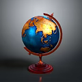 Decorative Desktop Globe With Red Stand Blue Oceans And Golden Continents On Gray Background
