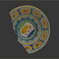 Chipped Ornate Ceramic Plate With Yellow Blue Green Patterns And Central Fish Design
