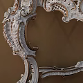 Ornate White Dressing Table With Carved Mirror And Orange Diamond Pattern Wall