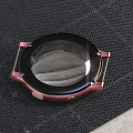 Smart Watches With Black White Straps Green Purple Dials And Case Parts On Desk