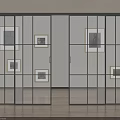Black Framed Glass Sliding Doors In Room With Framed Artworks And Wooden Floor