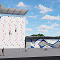 Large Colorful Outdoor Climbing Wall With People Climbing And Recreational Activities