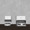 Sleek White Robotic Vacuum Cleaners In Modern Home With Wooden Floor And Gray Wall