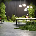 Garden Decor Scene with Moss Covered Elements Wooden Wall Hanging Lights and Table Chairs