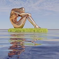 Golden Human Figure Sculpture sitting on green platform above water with clear reflection