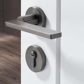 Modern Stainless Steel Door Handle With Keyhole On White Door In Home Interior