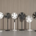 Multiple Standing Fans In White And Black Arranged Against Vertical Striped Wall On Gray Floor