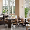 Modern Lounge Area Interior With Comfortable Chairs Green Plants Large Windows And Natural Light