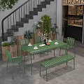 Commercial Outdoor Seating Space With Green Metal Table Chairs Bench And Plant Decorations