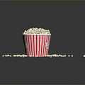 Fresh Popcorn in Red Striped Paper Cup with Scattered Pieces on Dark Background