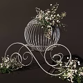 White Decorative Birdcage with Curved Scroll Legs and White Flowers Green Foliage on Dark Background