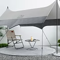 Outdoor Camping Tent Setup With Folding Chair Small Table And Green Plants