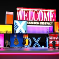 Vibrant Stage Setup With LED Screens Guitars Welcome Fashion District And Love Fitness Signs