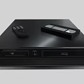 Modern Black Entertainment Media Player With Remote Control And Cassette Tape On Top