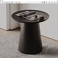 Round Black Wooden Coffee Table With Conical Base And Magazine Pinecones On Rug