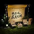 Cozy Garden Landscape Featuring Canopy String Lights Chairs Small Table Wooden Crates And Green Plants