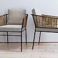 Stylish Dining Chairs with Rattan Armrests Black Metal Frames and Gray Cushions