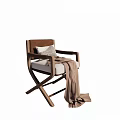 Stylish Cross Leg Wooden Frame Leisure Chair With Light Colored Cushion And Light Brown Blanket