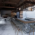 Rustic Outdoor Bar Area With Stone Counter Wooden Wall And White Chairs Under Glass Ceiling