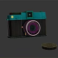Vintage Digital Camera With Turquoise Top And Black Body Featuring Classic Lens And Cap