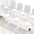 Modern Black Dining Table Set With White Plates Cutlery Wine Glasses And Black Chairs
