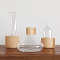 Modern Ceramic Vessels With Transparent Design And Brown Leather Wraps On Wooden Table