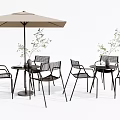 Outdoor Black Metal Table And Chair Set With Beige Umbrella And Plants
