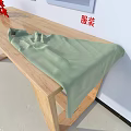 Light Green Clothing Laid on Wooden Table with Fashion Apparel Red Character Sign