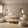 Modern Neutral Living Room Interior With Circular Sofa Round Coffee Table Pendant Light And Ottoman