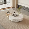 Round White Speckled Coffee Table On Beige Rug With Tray Green Plant In Modern Interior