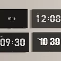 Four Black Modern TVs Showing Digital Time Display On Screens Against Gray Wall