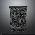 Ornate Metallic Cylindrical Container With Intricate Face Carvings And Decorative Patterns