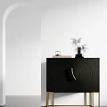 Black Textured Decorative Cabinet With Gold Legs And Green Plant Decor On Top