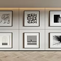 Framed Black And White Abstract Artworks On Light Colored Wall With Wooden Floor