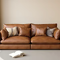 Brown Leather Two Seater Sofa With Neutral Throw Pillows In Cozy Living Room