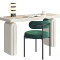 Cream Colored Desk With Open Book White Coffee Cup Stacked Decorative Objects And Green Chair