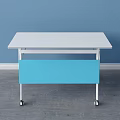 White Tabletop Desk With Blue Panel Sturdy White Frame And Wheels On Gray Floor