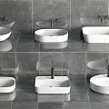 Various Shapes Of White Washbasins On Gray Tiled Bathroom Wall Design